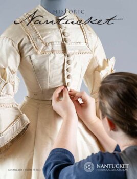 Cover of Historic Nantucket Magazine featuring a woman buttoning a dress on a mannequin.