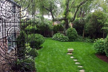 Greater Light garden view through wrought iron gates.