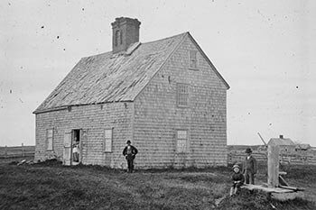 Oldest House, ca. 1860, with members of the Turner family posing for the camera.