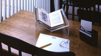 Desk at NHA Research Library with open book, paper, and pencil.