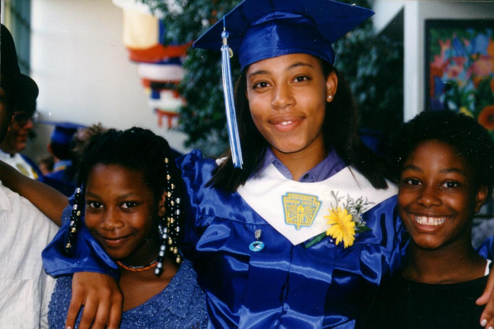 Girl in high school graduation cap and gown.