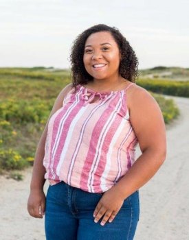 Young woman standing on the beach.